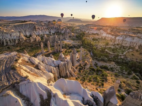 cappadocia love valley at sunset with balloons